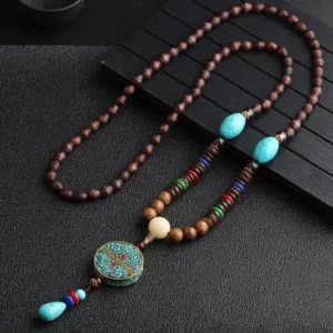 Turquoise Dzi bead prayer wheel wenge wood meditation necklace with colorful agate spacer beads, displayed on wooden stand