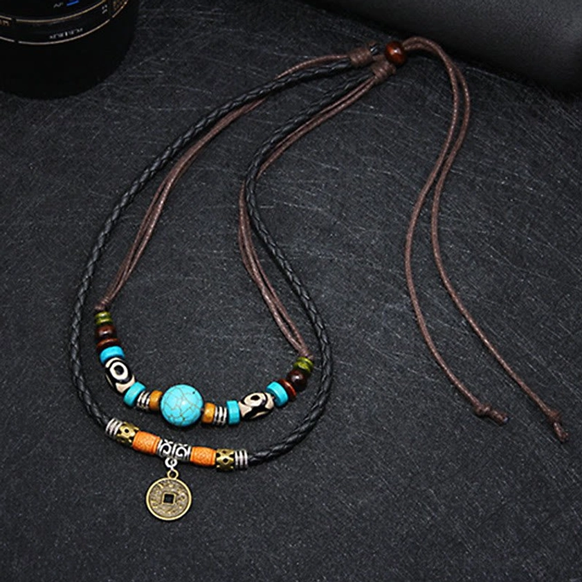 Side view of turquoise Dzi bead Buddhist necklace displaying adjustable tie straps and full pendant with bead strand