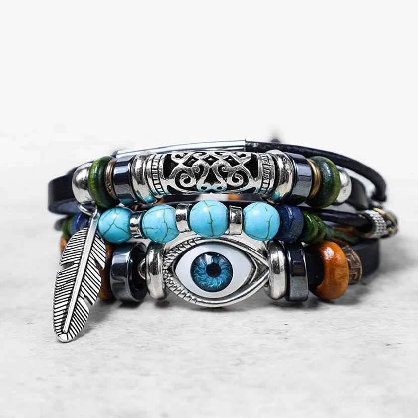 Buddhist turquoise bracelet with complete Evil Eye decoration and feather pendant, right front angle