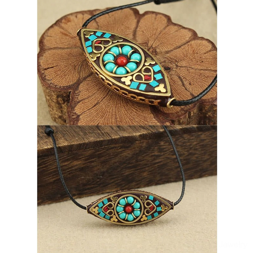 Turquoise Buddhist marquise pendant necklace showing front face design and decorative stone inlays
