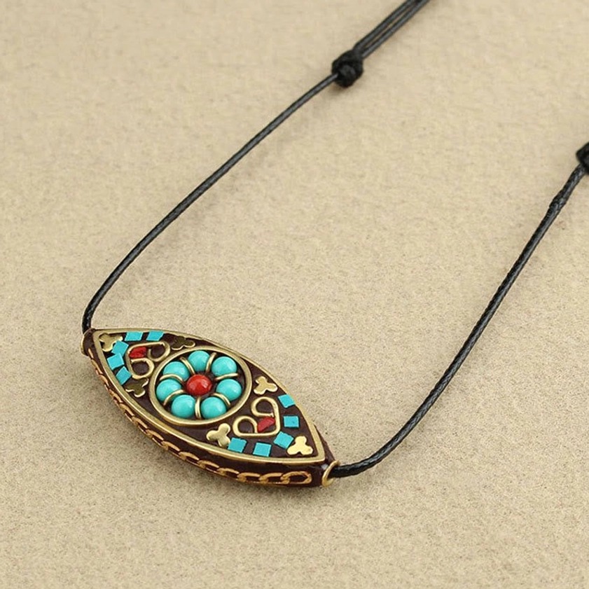 Adjustable turquoise marquise Buddhist pendant on black wax rope with central red bead design