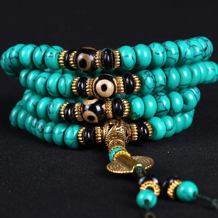 Turquoise Buddhist mala necklace with gold tassel and stacked prayer strands