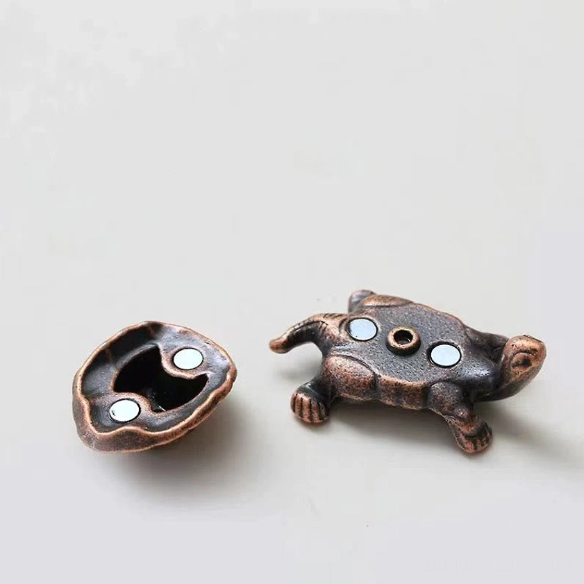 Detachable turtle incense holder flat lay view showing magnetic attachment points and shell-base separation