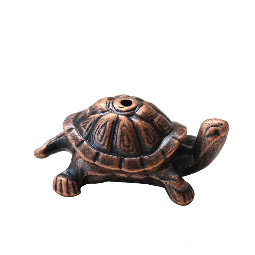 Metal turtle incense holder side profile view with smooth rounded shape and carved shell texture on white background