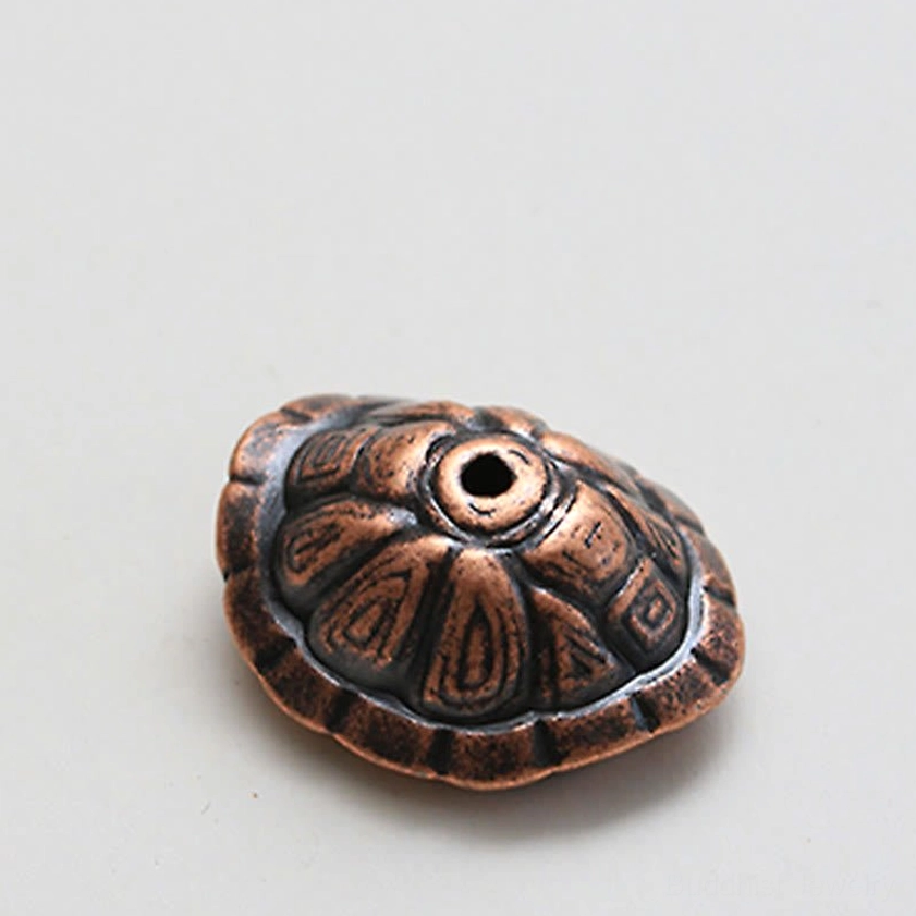 Close-up overhead view of turtle carapace incense top with intricate shell carvings and central incense insertion hole