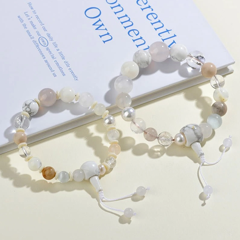 Two matching white agate pearl bracelets with brown and white beads and metal spacers flat lay