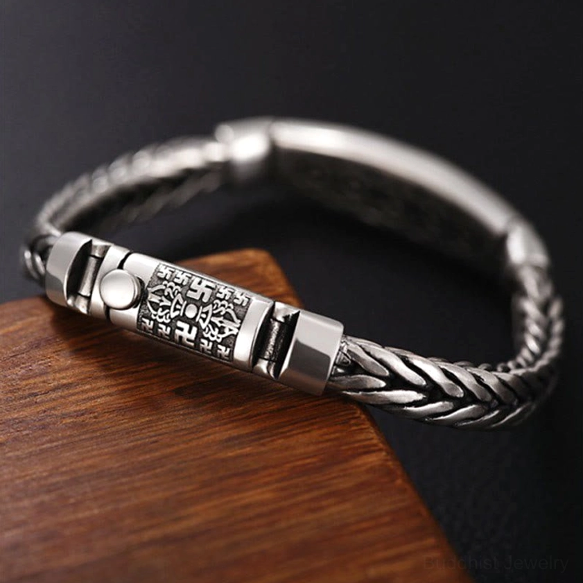 Oblique angled view of Vajra Buddhist bracelet displaying intricate braided wheat chain and push-type magnetic closure mechanism