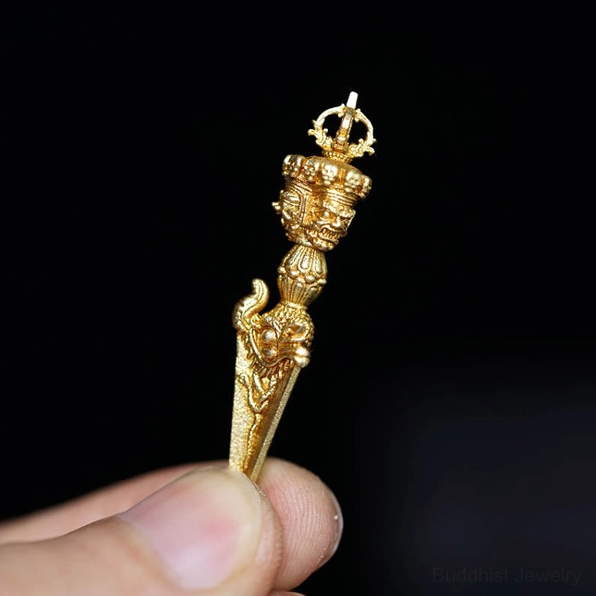 Buddhist vajra dorje amulet with ornate ritual carvings held by fingers side angle