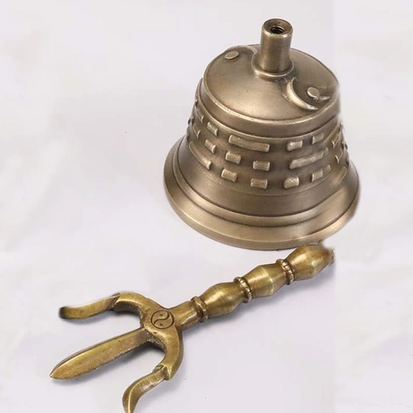 Complete vajra dorje and meditation bell ritual set flat lay, antique bronze finish with yin-yang symbol on dorje head, top-down view