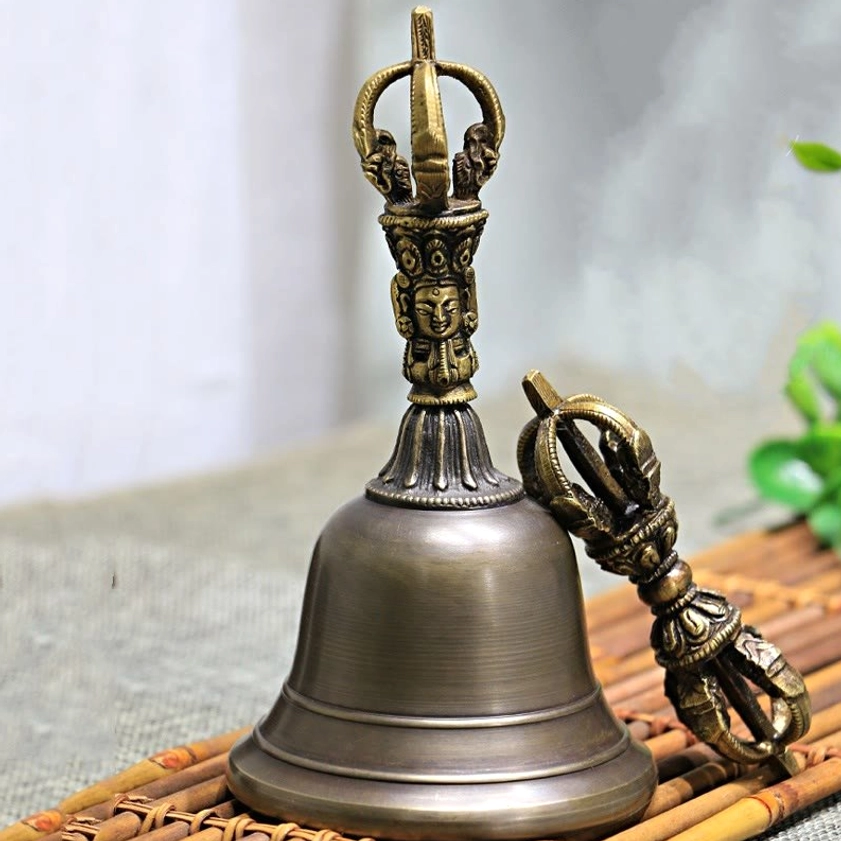 Close-up detail of handcrafted vajra dorje with five-pronged design and ornate carved handles, showcasing traditional Himalayan craftsmanship