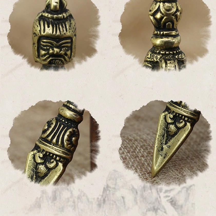 Isolated close-up details of handmade copper vajra dorje showing head section, shaft components and pointed blade