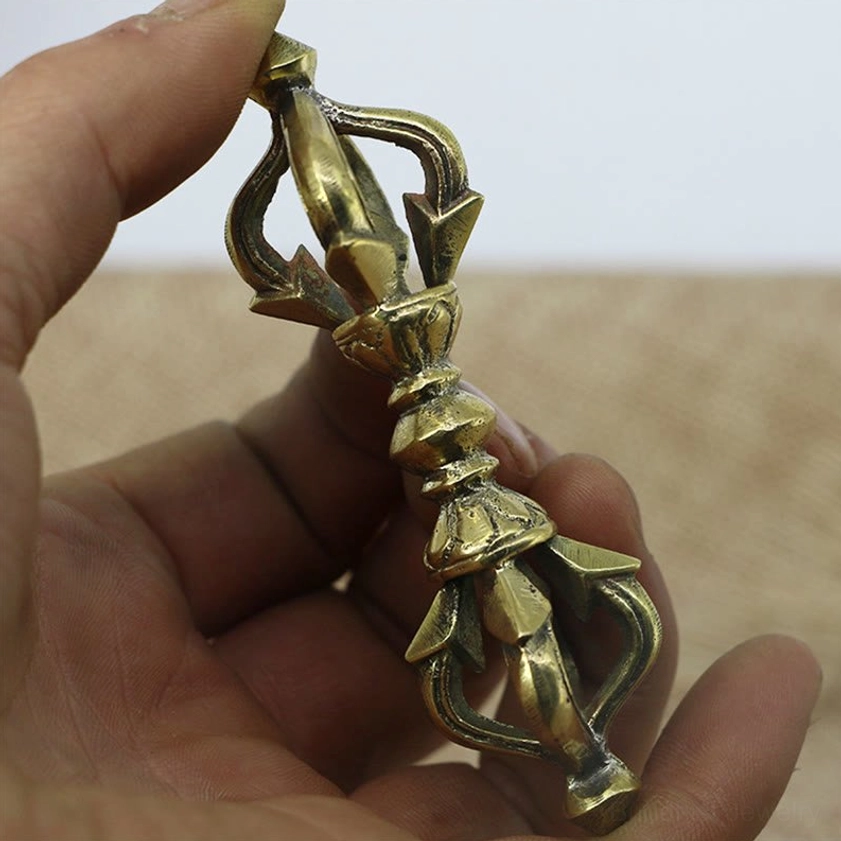 Handheld five prong vajra dorje showing full length and authentic bronze copper coloring for Buddhist meditation practice