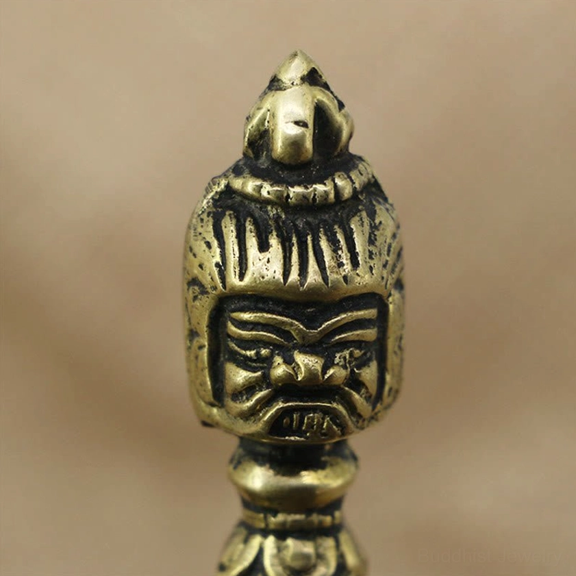 Tibetan vajra dorje deity head close-up showing fierce facial expression and ornate carved headdress decoration
