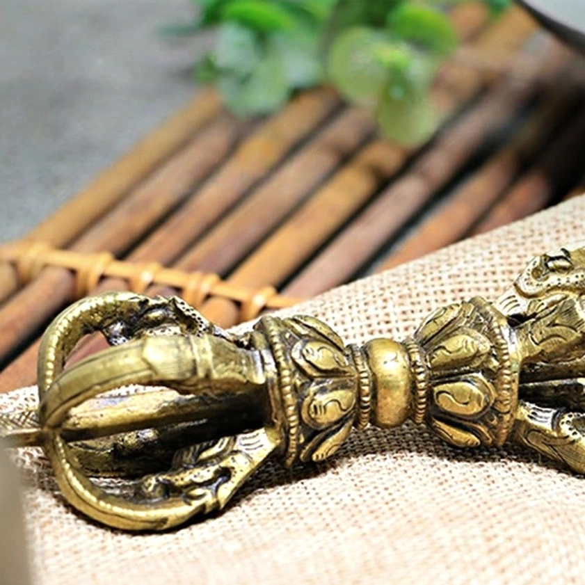 Overhead flat lay view of five-pronged vajra dorje on linen showing complete ritual instrument geometry