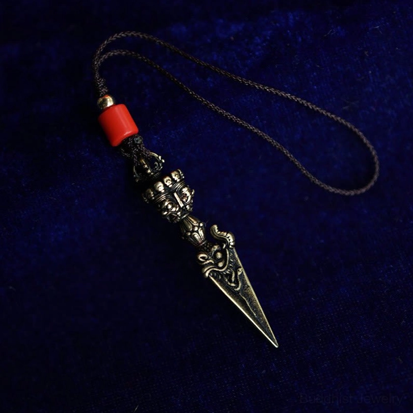 Vajra dorje pendant with red decorative bead and brown braided rope hanging decoration