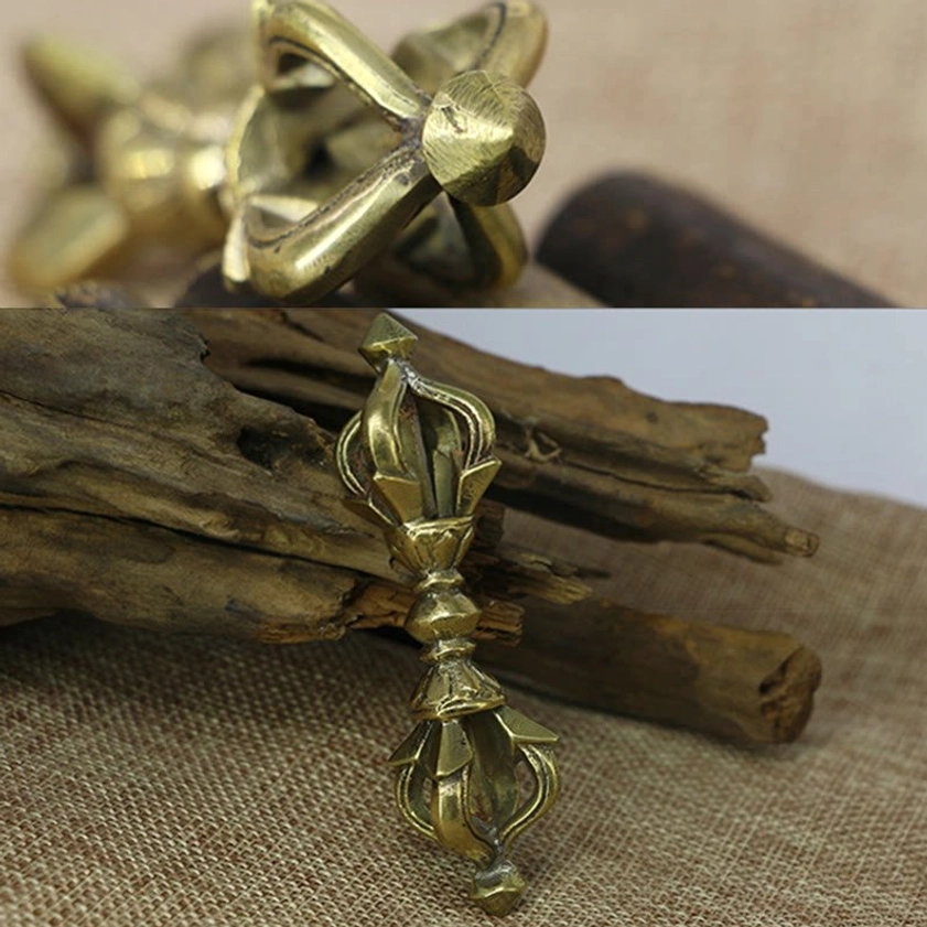 Handcrafted five prong vajra dorje placed on rustic natural background with authentic antique brass patina