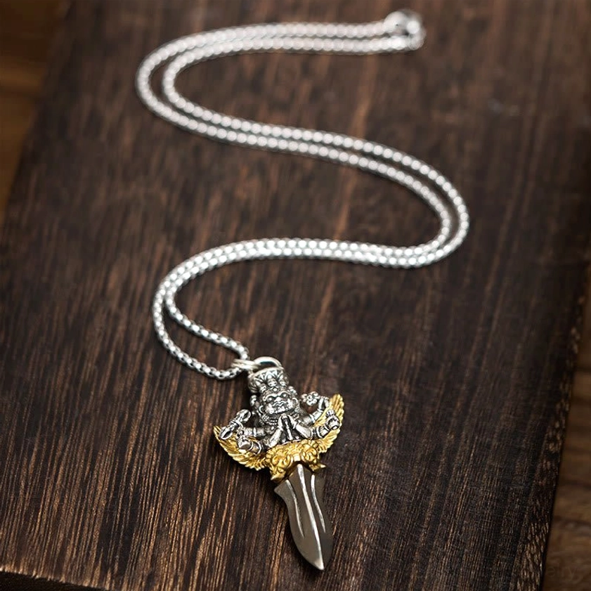 Vajra copper pendant necklace overhead flat lay on dark wooden table, showing coiled silver chain with antique finish and complete necklace length