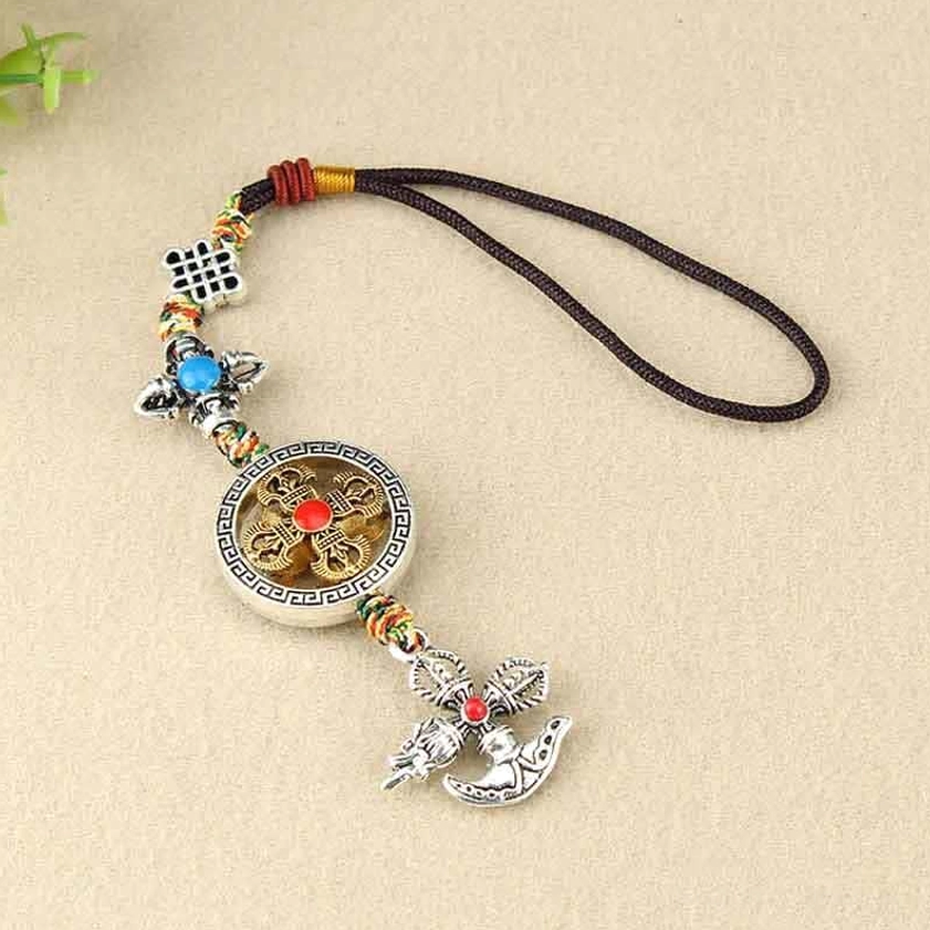 Spiritual vajra hanging ornament featuring red central gemstone on round pendant and silver vajra charm with colorful braided cords