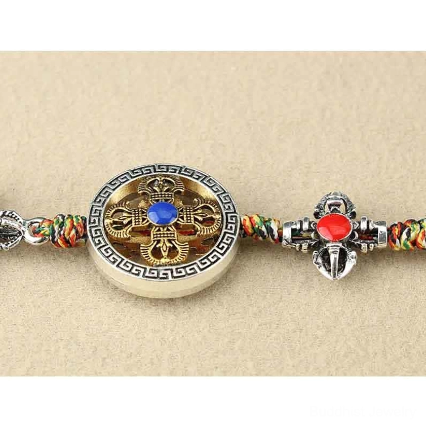 Vajra hanging decoration showcasing silver metal craftsmanship with gemstone details and traditional Buddhist symbolism