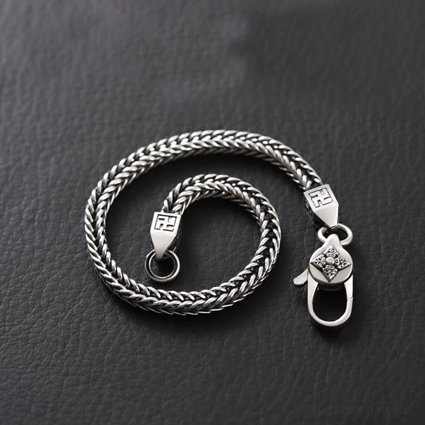 Handmade double vajra Buddhist bracelet coiled display showing full chain and swastika decorative elements