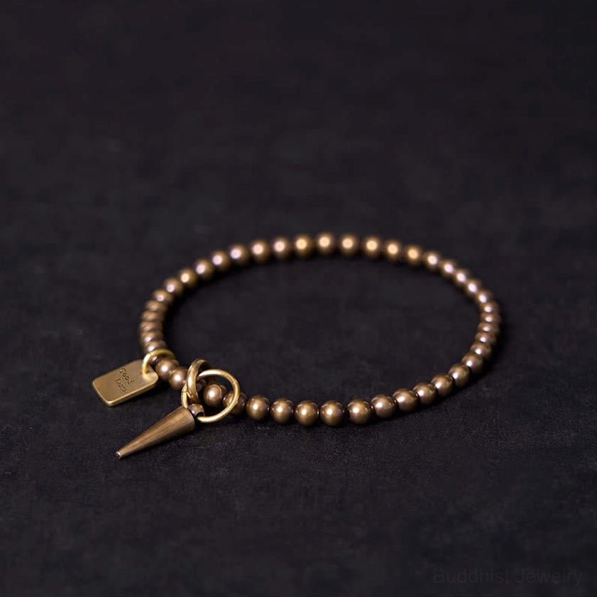 Antique copper brass beaded bracelet side view with Good Luck pendant and spring ring detail