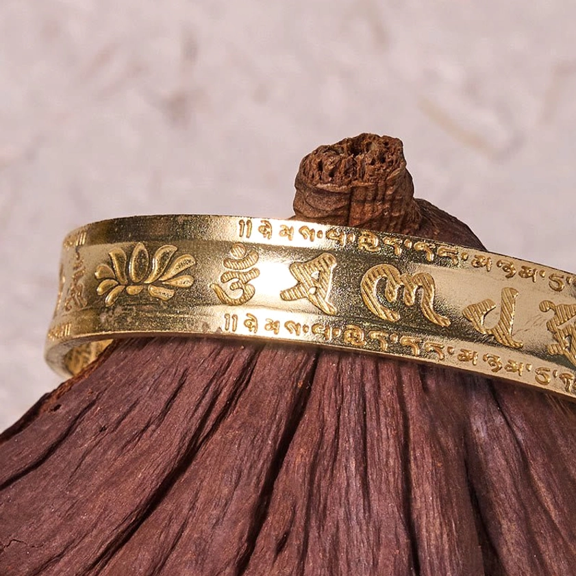 Vintage brass Om Mani Padme Hum cuff bracelet with patina finish and lotus symbol carving