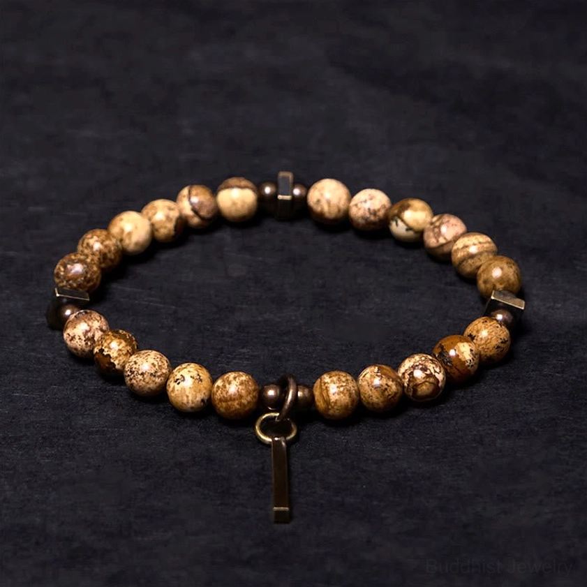 Vintage-style copper beaded bracelet with natural stone and dark copper fasteners three-quarter flat lay
