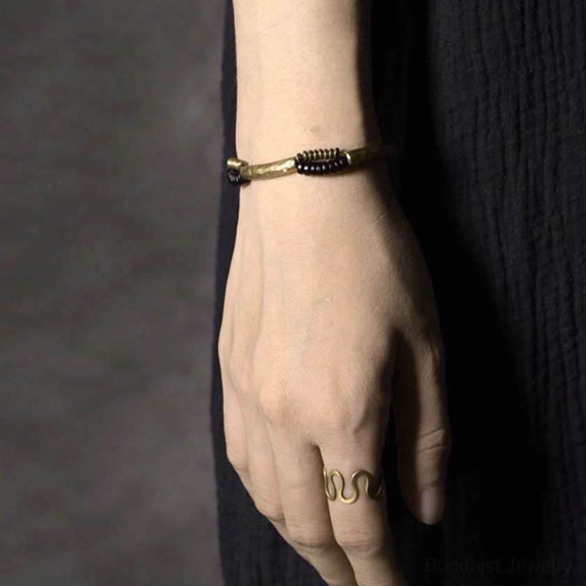 Vintage ebony wood and copper Buddhist bracelet for protection and abundance featuring artisan handcrafted design elements