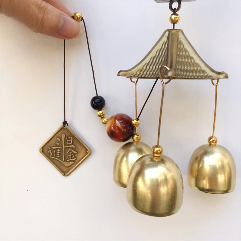 Handmade wealth cat chime components overhead view brass bells pavilion beaded cord