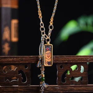 Five Gods of Wealth thangka titanium steel pendant necklace with gold chain and braided tassel on vintage wooden desk