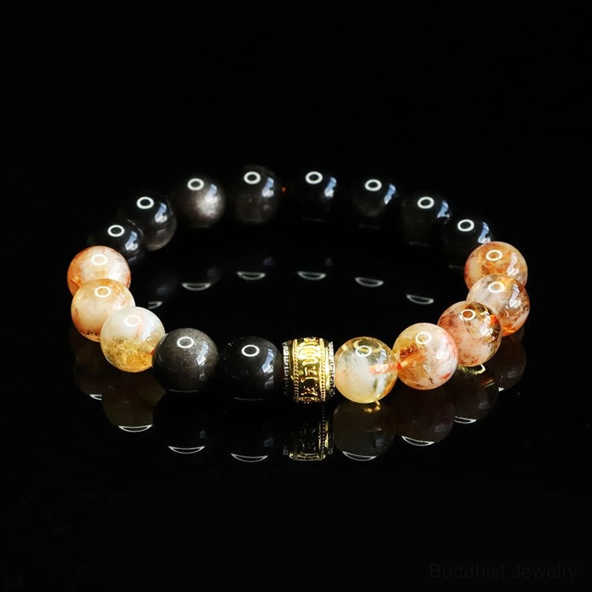 Healing gemstone bracelet with obsidian and citrine beads displaying clear reflection on black background, showing bead quality