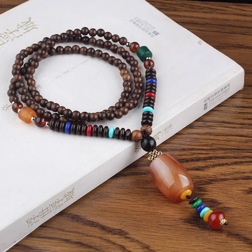 Wenge wood beaded necklace featuring brown resin ball pendant with natural Buddhist grounding energy