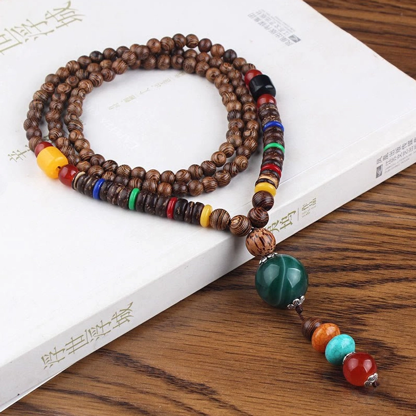Wenge wood beaded necklace featuring round green agate pendant with colorful spacer beads and brown wooden chain