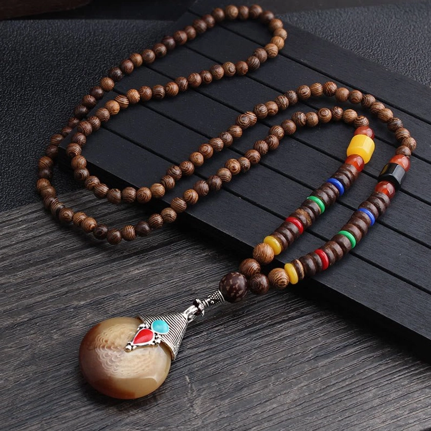 Wenge wood Buddhist necklace with natural horn-style pendant and silver metal accents on colorful wooden beads