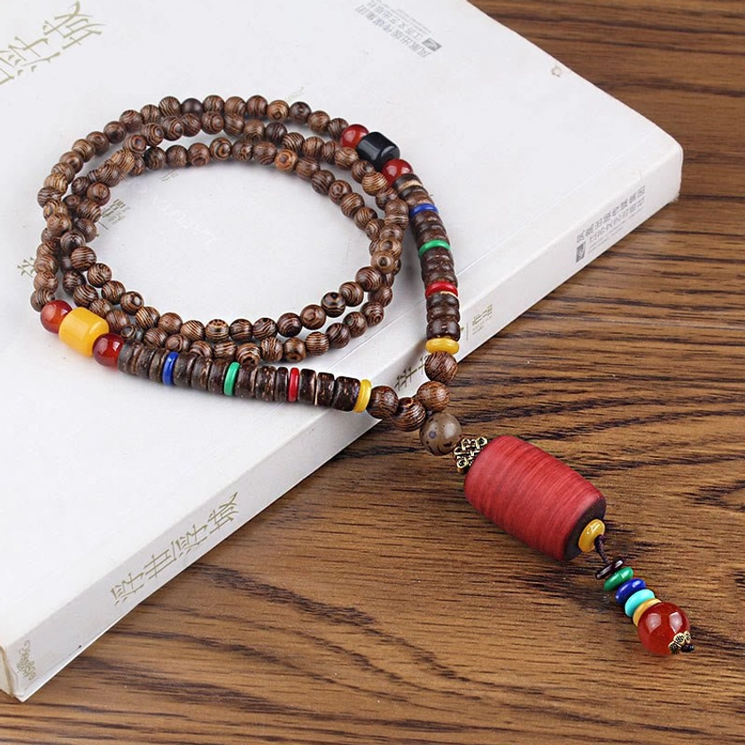 Handmade Wenge wood necklace with red cylinder bead design and natural protective Buddhist symbolism