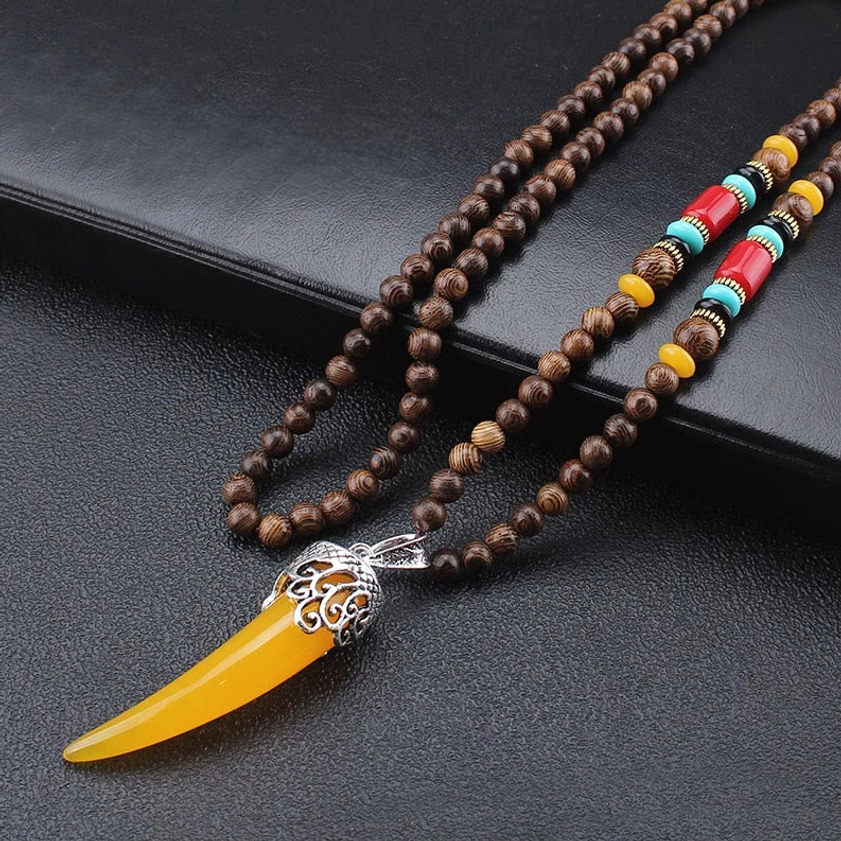 Wenge wood turquoise horn pendant necklace with silver carved bail and ethnic wooden bead accents angled view