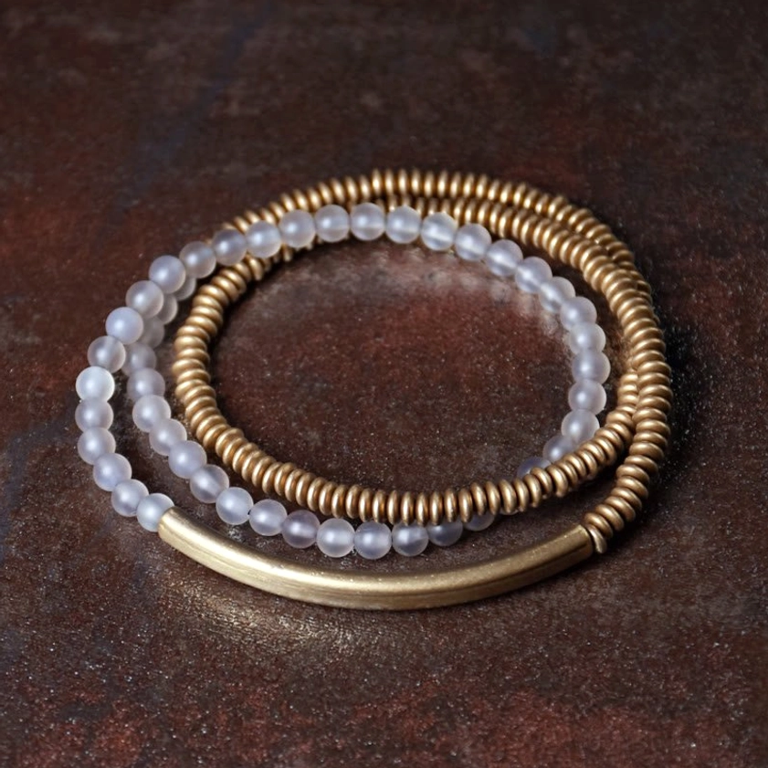 White agate gemstone Buddhist blessing bracelet showing smooth polished 4mm beads with natural milky white color and protective brass metalwork