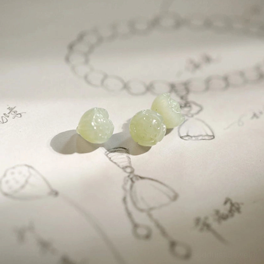 Hand-drawn bracelet design sketch with matching jade spacer and lotus pendant sample beads flat lay