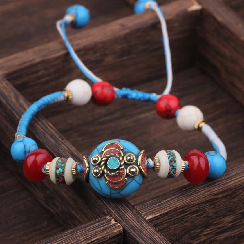 White blue rope Buddhist bracelet with blue woven braided cord and intricate central bead, adjustable meditation bracelet