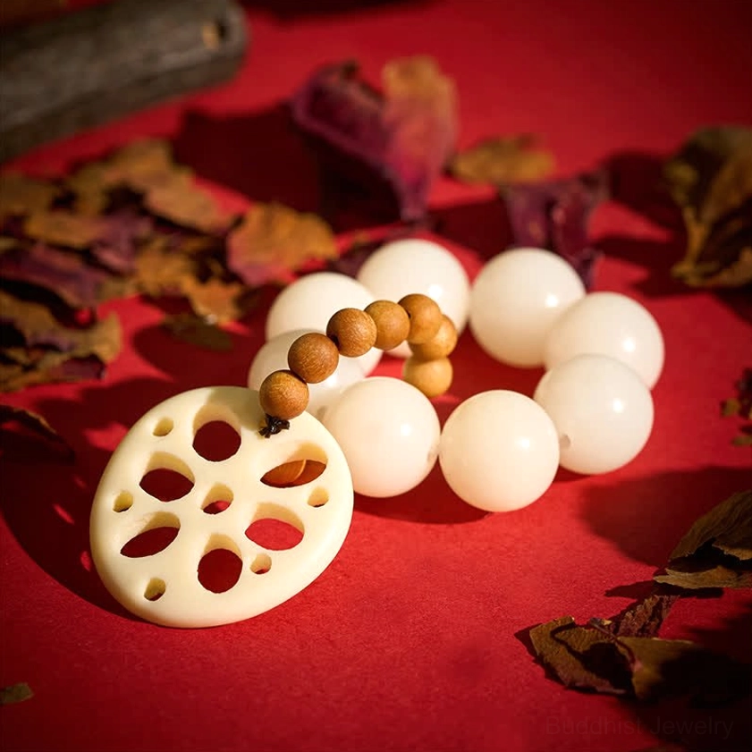 Bodhi seed meditation bracelet set with loose beads and carved lotus pendant arranged on red fabric background
