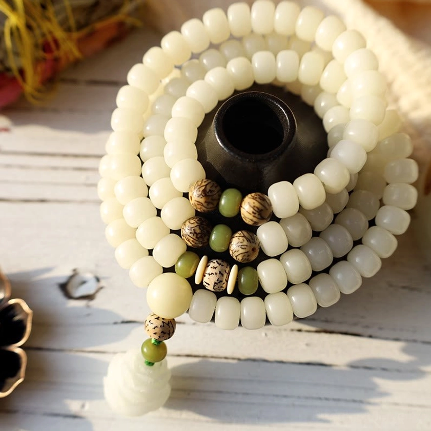 White bodhi beads with green accent beads and carved lotus flower pendant, mala detail shot