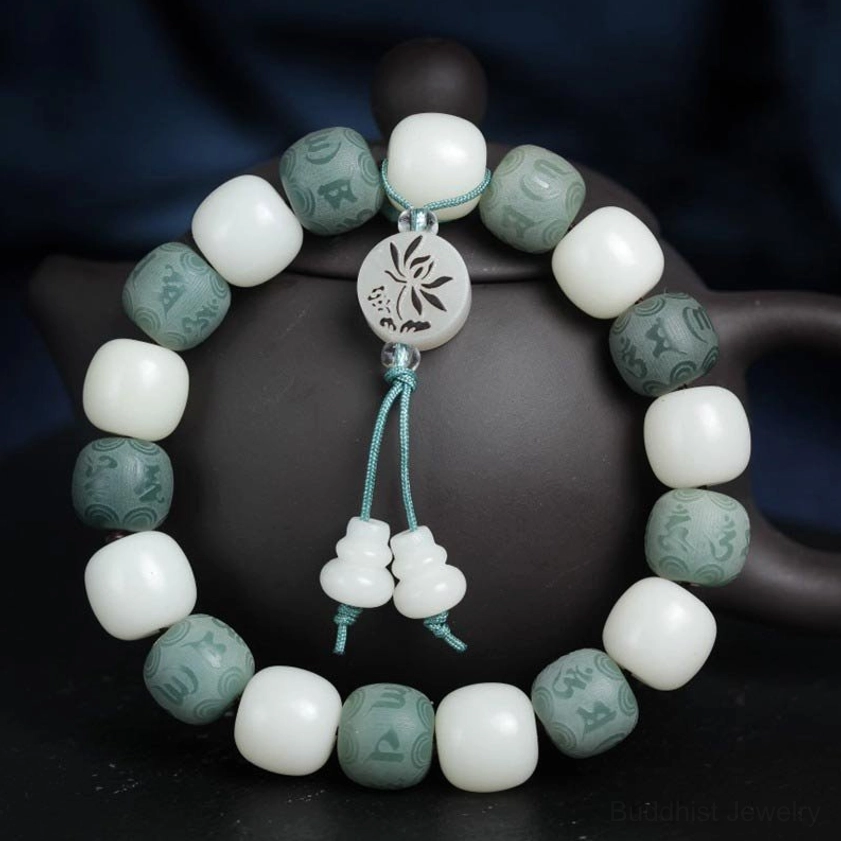 Front-facing view of handmade white bodhi six-word mantra bracelet displaying full circular bead arrangement with lotus charm