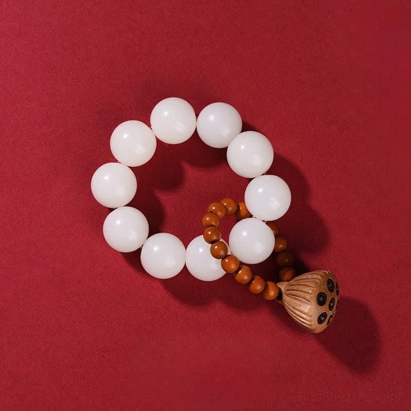White bodhi seed meditation mala beads showing pure white seeds with dark speckles and lotus pod charm for wisdom and enlightenment practice