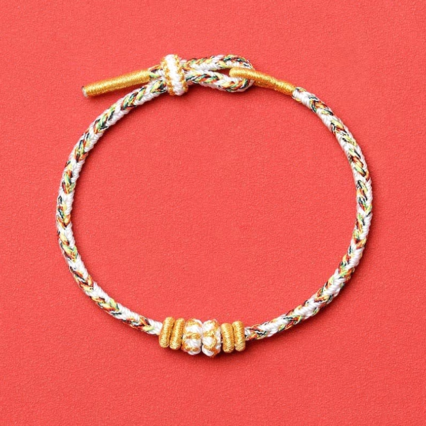 Minimalist white braided Om Mani Padme Hum bracelet on solid red background showing plain woven cord design