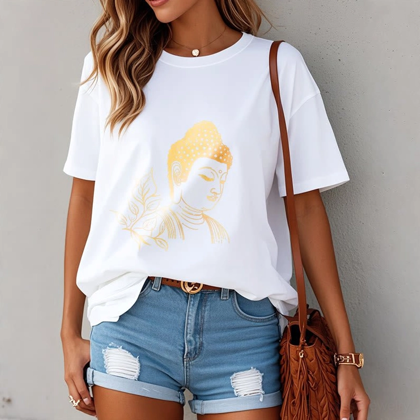 Woman styling white Buddhist tee with gold leaf print paired with denim shorts and crossbody bag