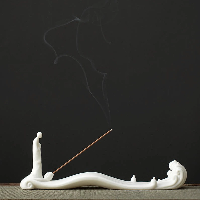 Buddhist ceramic incense burner in serene white finish showing authentic monk and wave sculpture