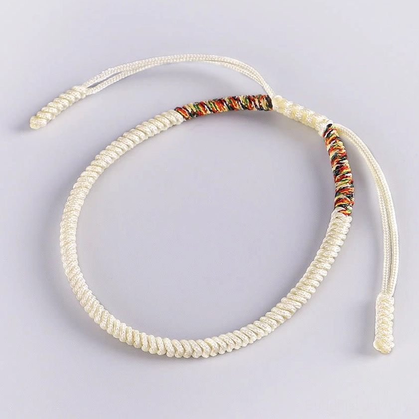 White Buddhist King Kong Knot bracelet with colorful woven accent, handcrafted for meditation and spiritual practice