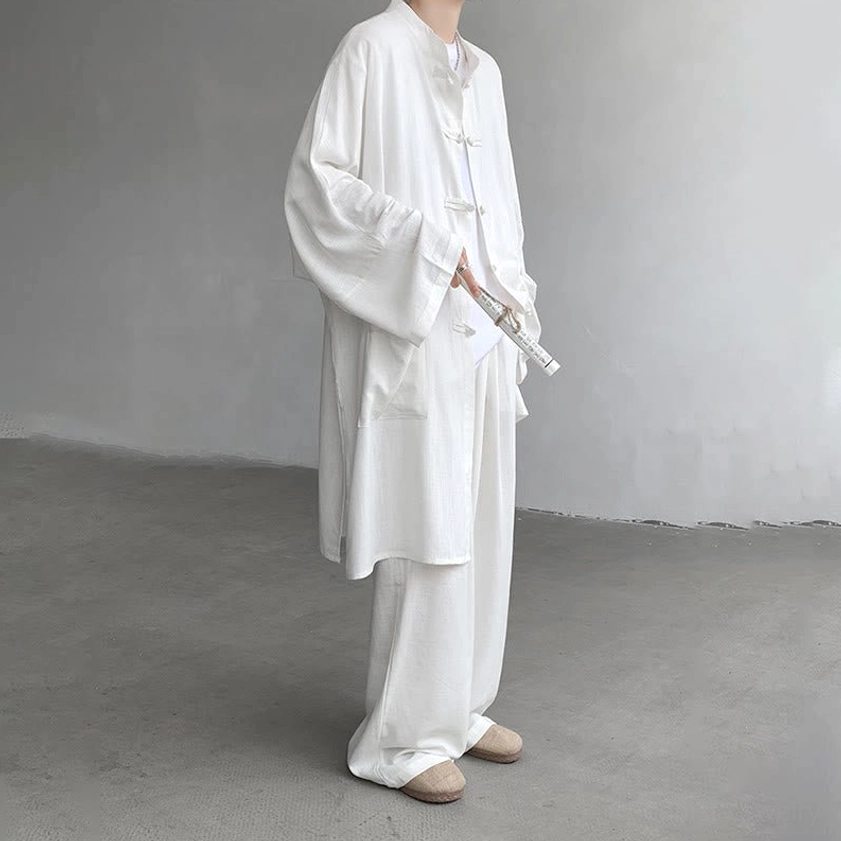 White Buddhist meditation wear front view with decorative oiled paper umbrella prop and tassel detail