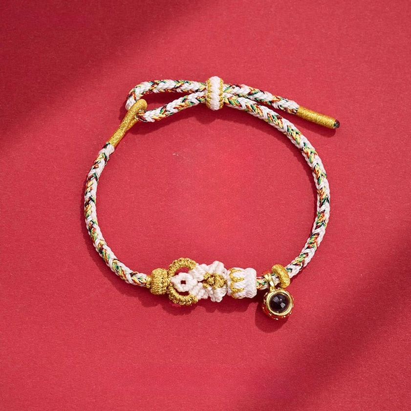 White Buddhist string bracelet with hand-woven Buddha knot and black bead charm for spiritual clarity