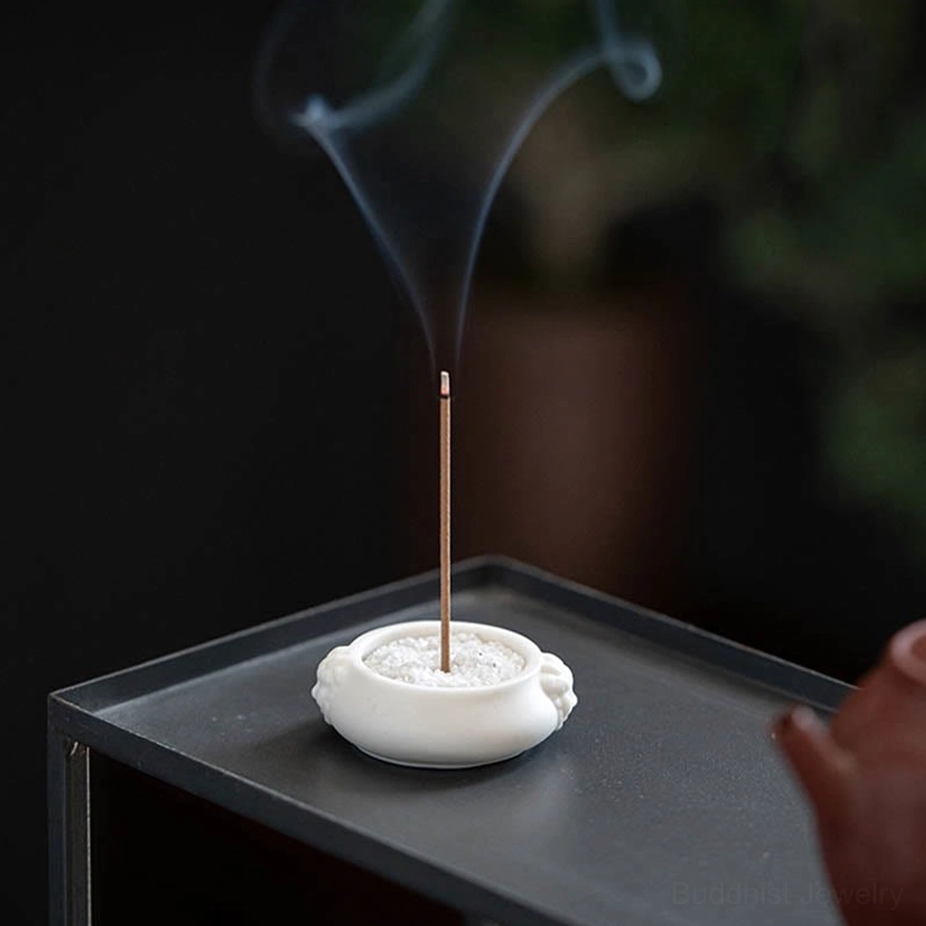 White matte ceramic incense burner with Buddhist motifs, ideal for creating peaceful atmosphere in any room